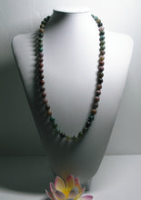 Load image into Gallery viewer, a close up of a baseball glove and a ball in it