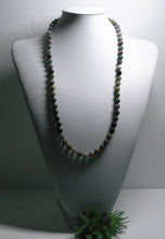 Load image into Gallery viewer, a close up of a baseball glove and a ball